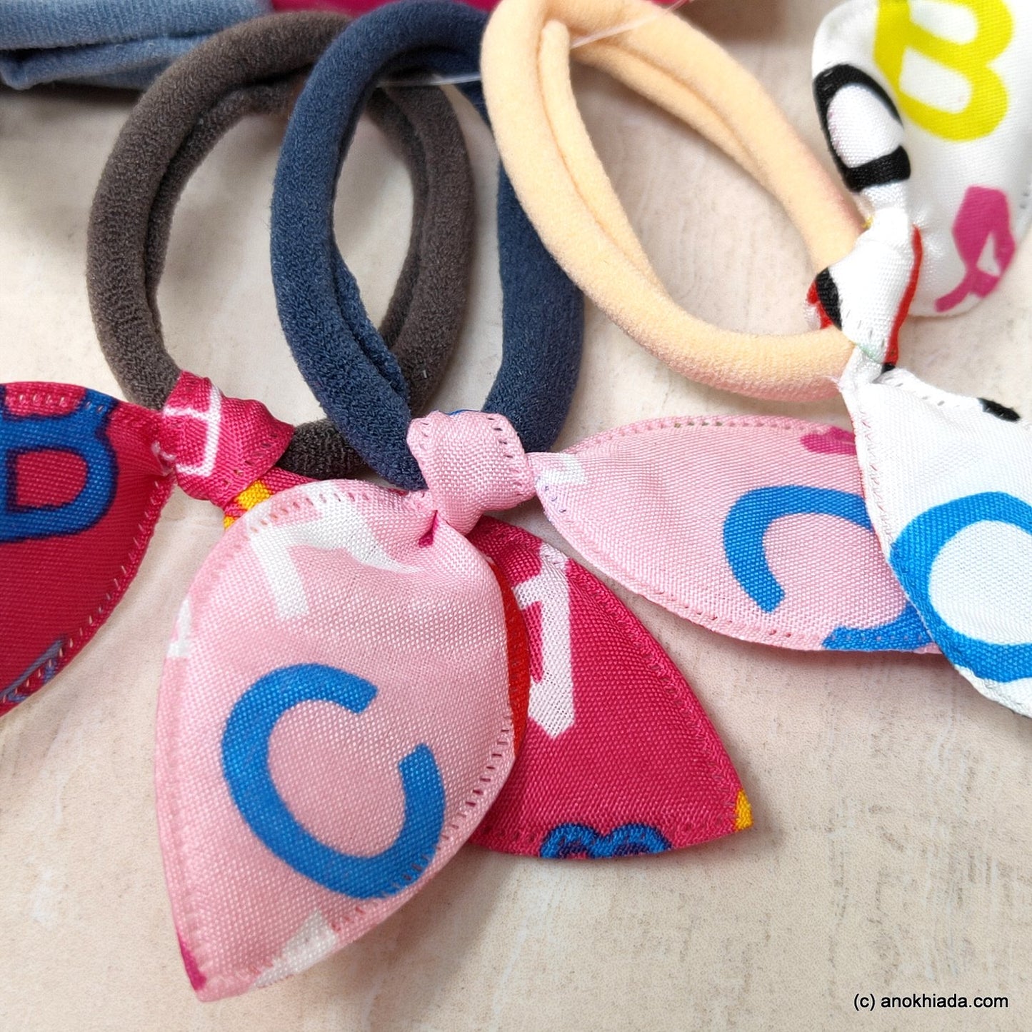 Anokhi Ada Alphabets Print Hair Ties/ Hairbands for Girls and Women (ZG-41a Ponytail Holders, 4 Pcs Assorted Colour Rubber)